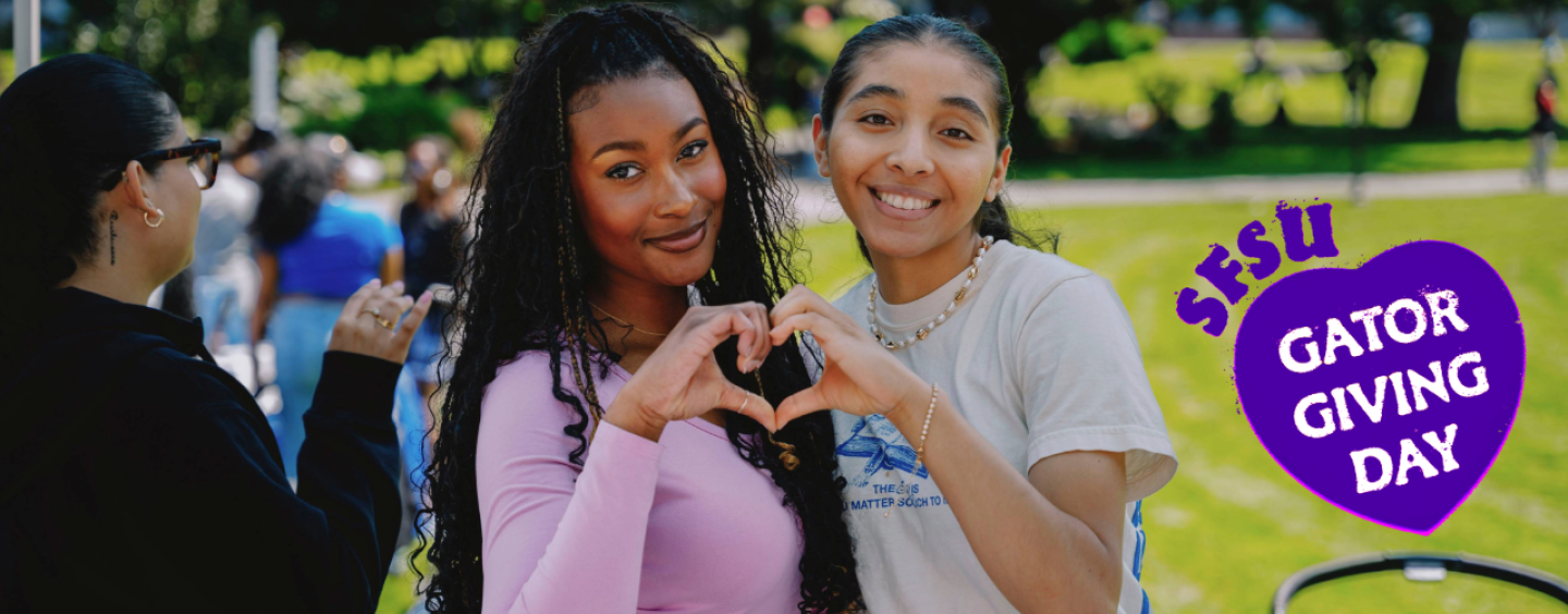 two women on campus make a heart with their hands for SFSU Gator Giving Day