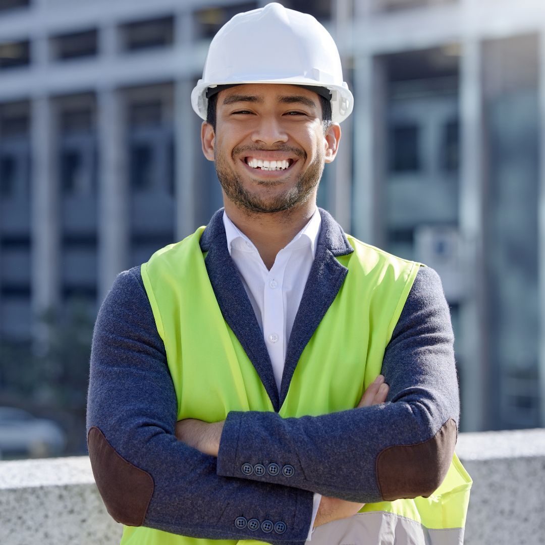 Construction professional siles in a hard hat