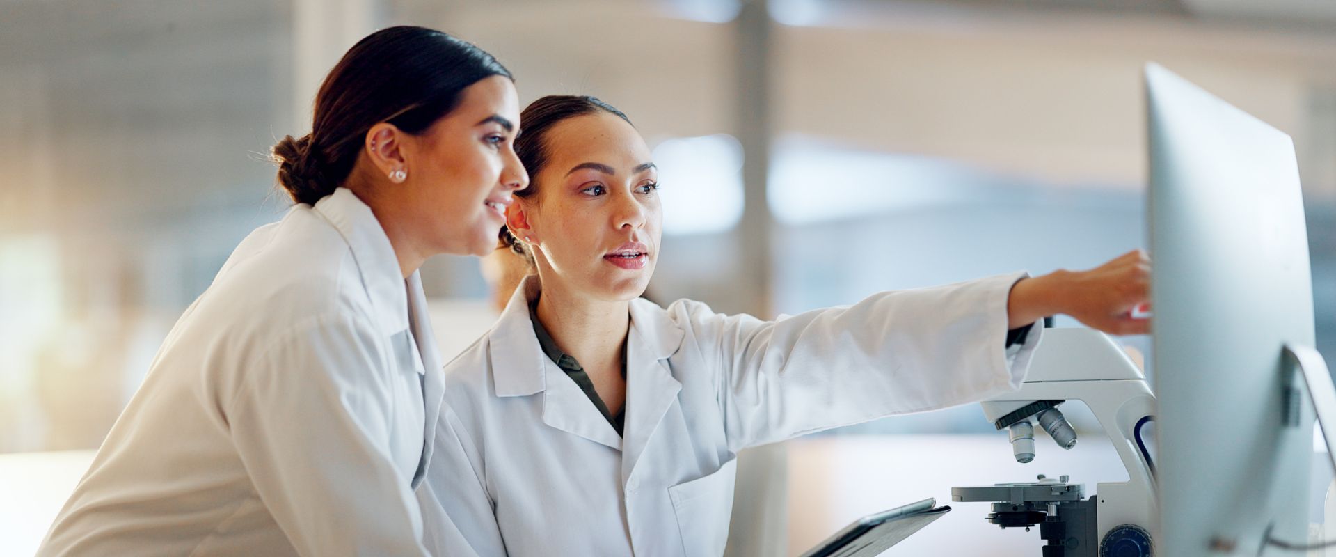 EKG technicians point and look at computer screen