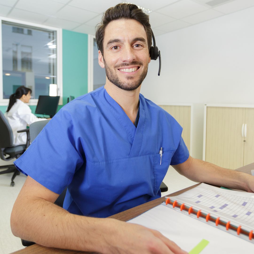 Medical administrative assistant wearing headset at a desk