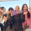 International students ride Muni and hold up an SFSU pennant