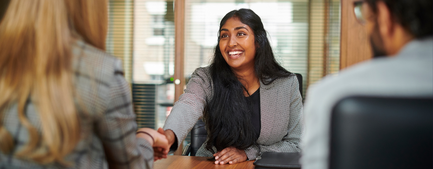 Paralegal shakes hands at a job interview