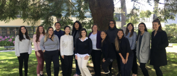 A group of Dietetics interns under a tree on campus